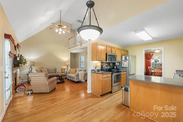 a living room with fireplace furniture and a wooden floor