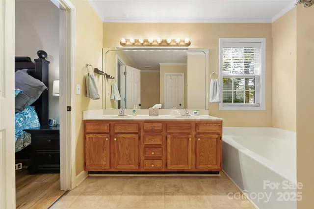a bathroom with a tub sink and mirror