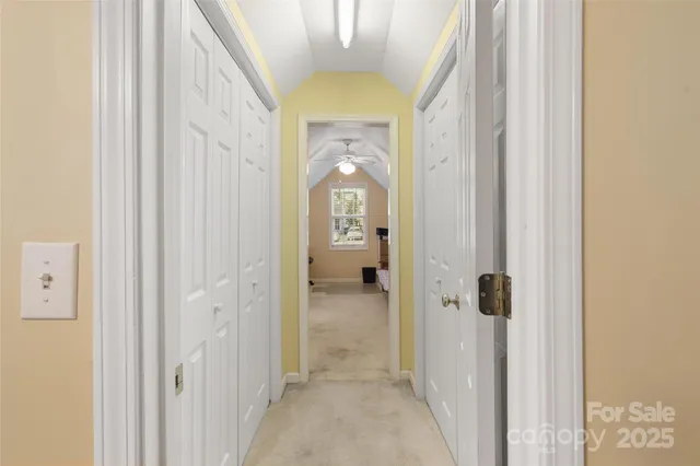 a view of a hallway view with wooden floor and staircase