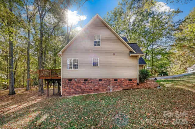 a view of house with backyard and trees