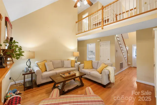a living room with furniture a rug and a chandelier