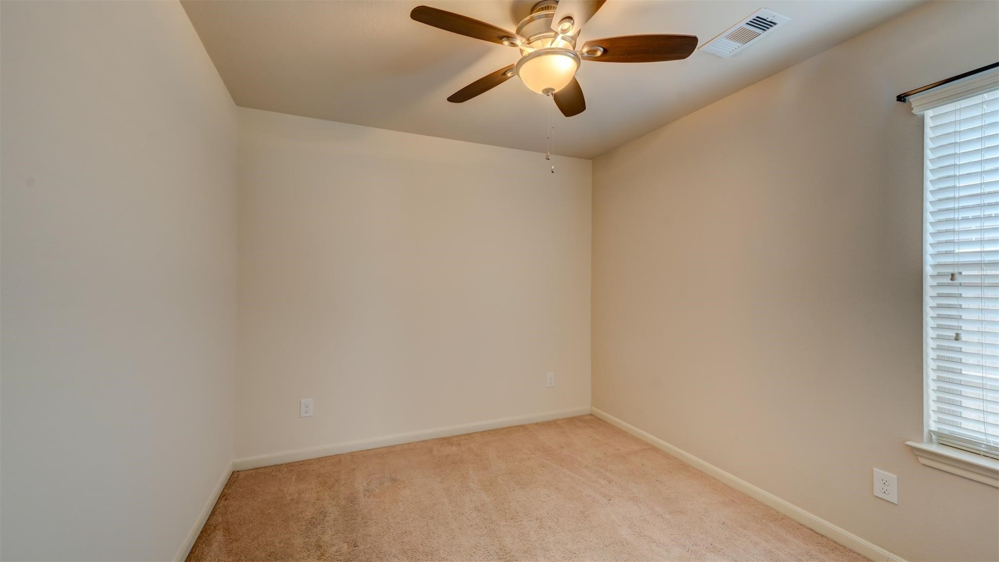 2831 Lockeridge Bend Drive Spring, TX 77386 - Photo 11 of 16 an empty room with a window and a fan