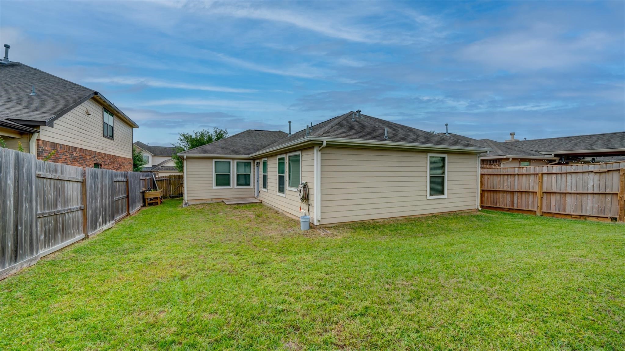 2831 Lockeridge Bend Drive Spring, TX 77386 - Photo 15 of 16 a view of a backyard with plants and large tree