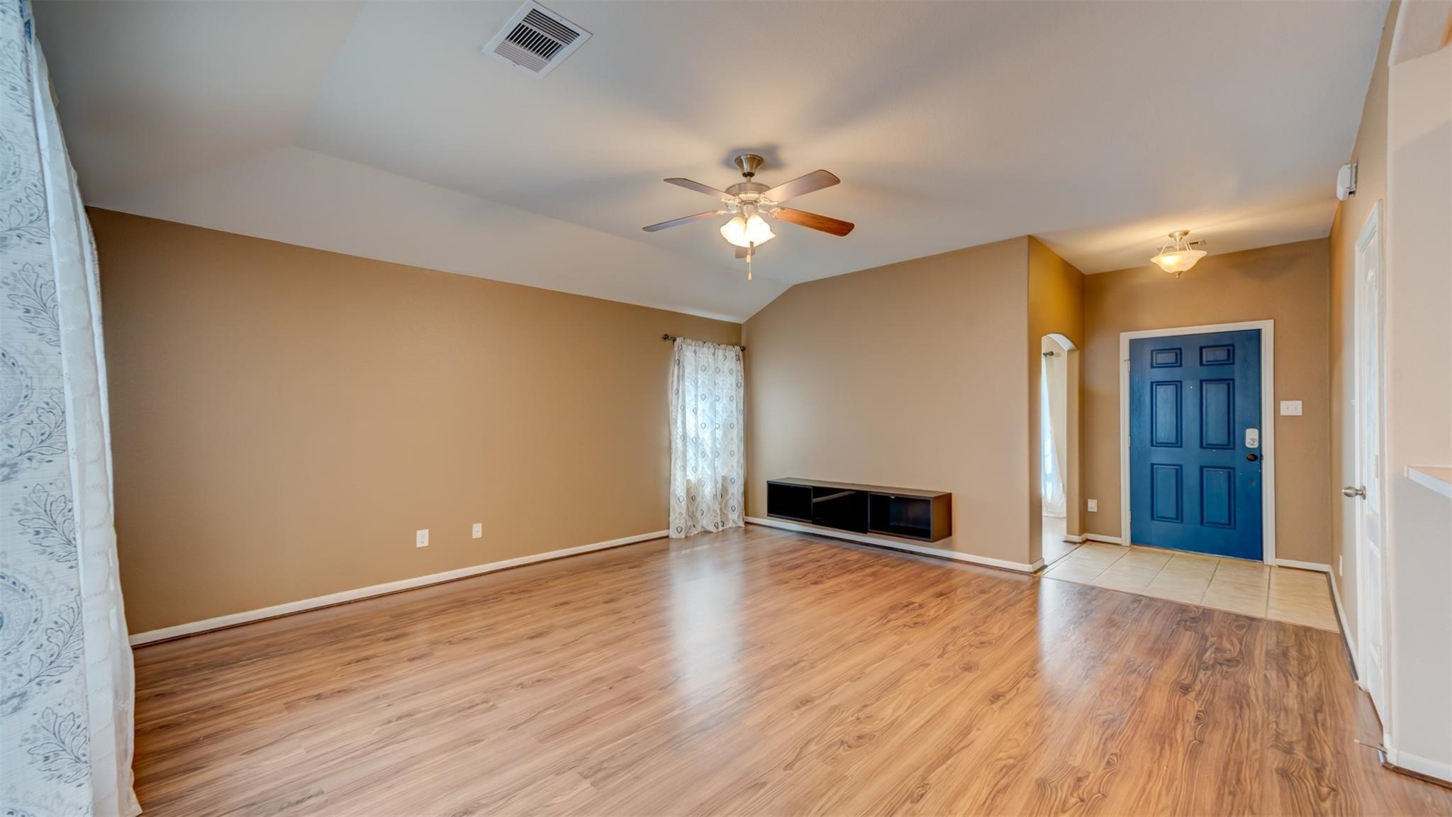 2831 Lockeridge Bend Drive Spring, TX 77386 - Photo 2 of 16 wooden floor in an empty room with a window