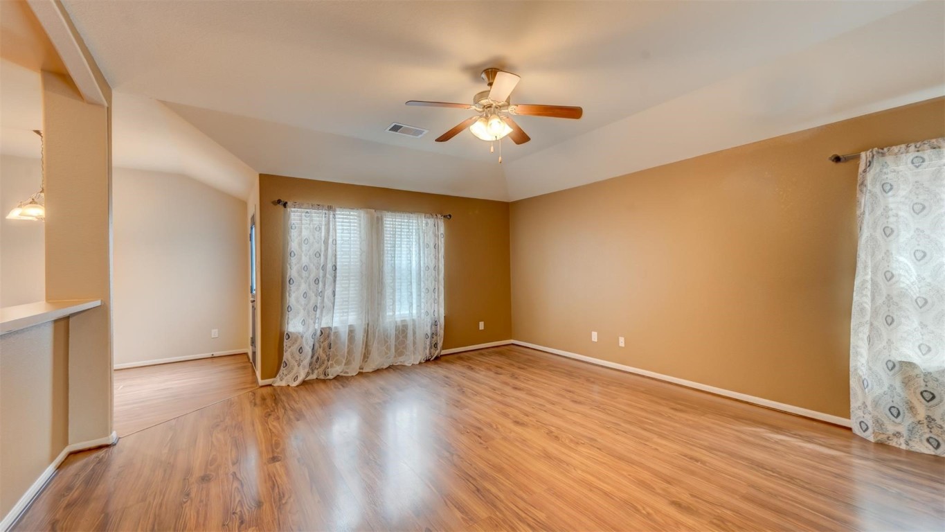 2831 Lockeridge Bend Drive Spring, TX 77386 - Photo 3 of 16 an empty room with wooden floor fan and windows