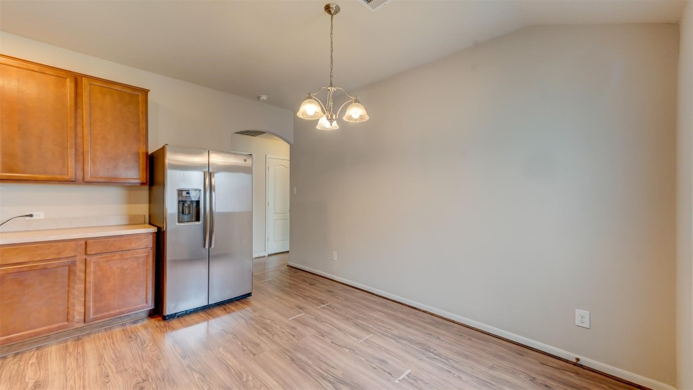 2831 Lockeridge Bend Drive Spring, TX 77386 - Photo 6 of 16 a kitchen with stainless steel appliances granite countertop a refrigerator a sink dishwasher and wooden floor
