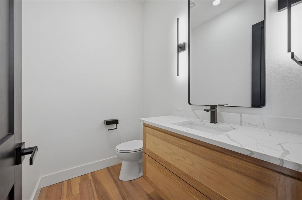 1805 Arthur Road Denison, TX 75021 - Photo 10 of 40 a bathroom with a granite countertop toilet sink and mirror