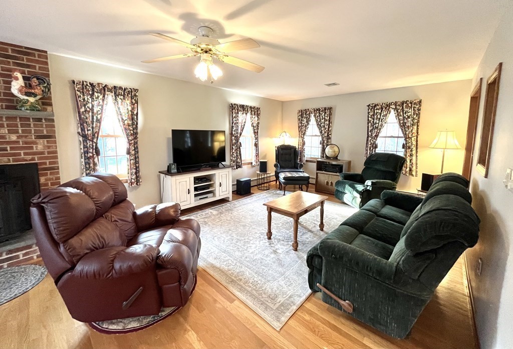 59 Uptack Road Groveland, MA 01834 - Photo 16 of 37 a living room with furniture and a flat screen tv