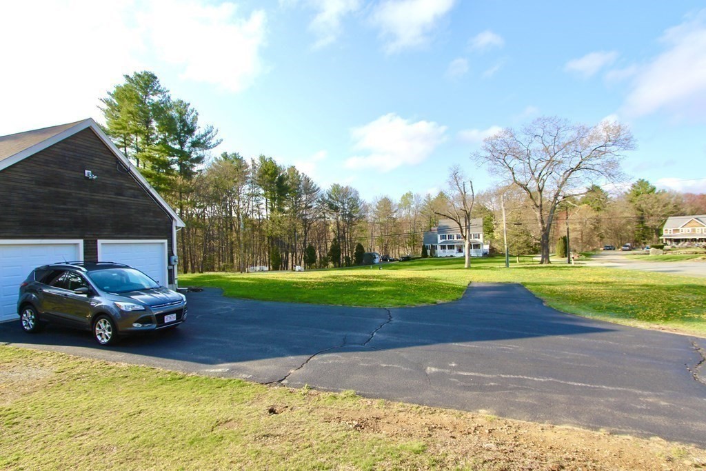 59 Uptack Road Groveland, MA 01834 - Photo 36 of 37 a car parked in front of a house with a yard
