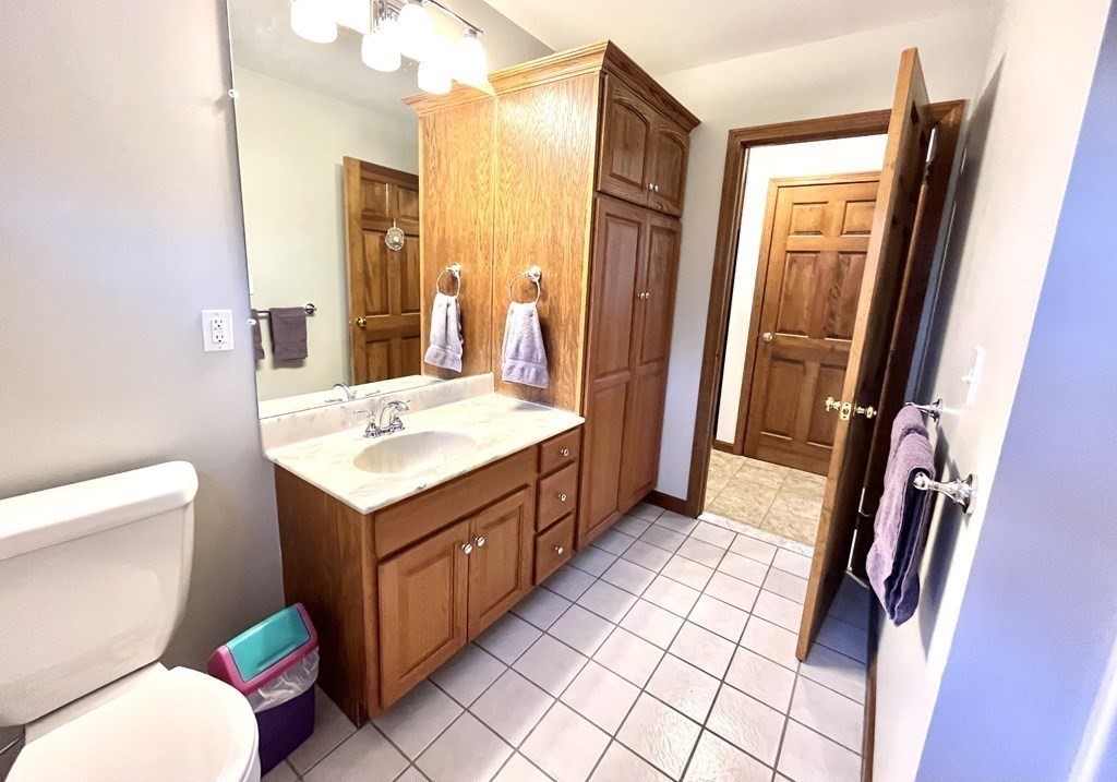 59 Uptack Road Groveland, MA 01834 - Photo 8 of 37 a bathroom with a sink a toilet and a mirror