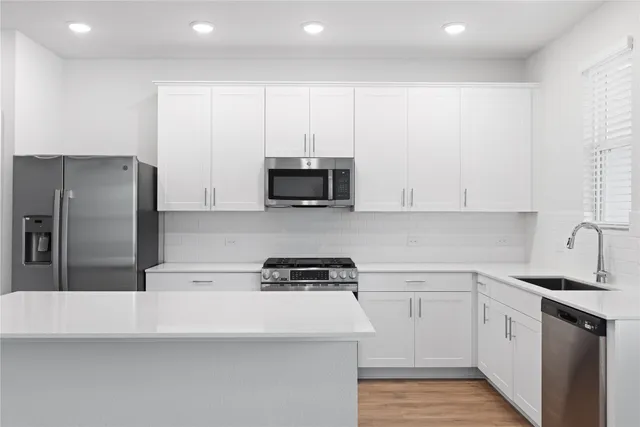 a kitchen with cabinets and stainless steel appliances