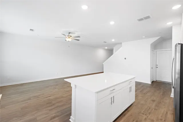 a view of a kitchen with sink and dishwasher with wooden floor