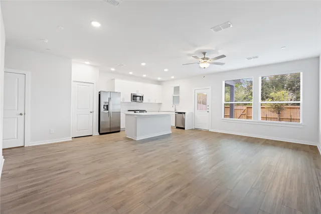 a view of a kitchen with wooden floor and a kitchen