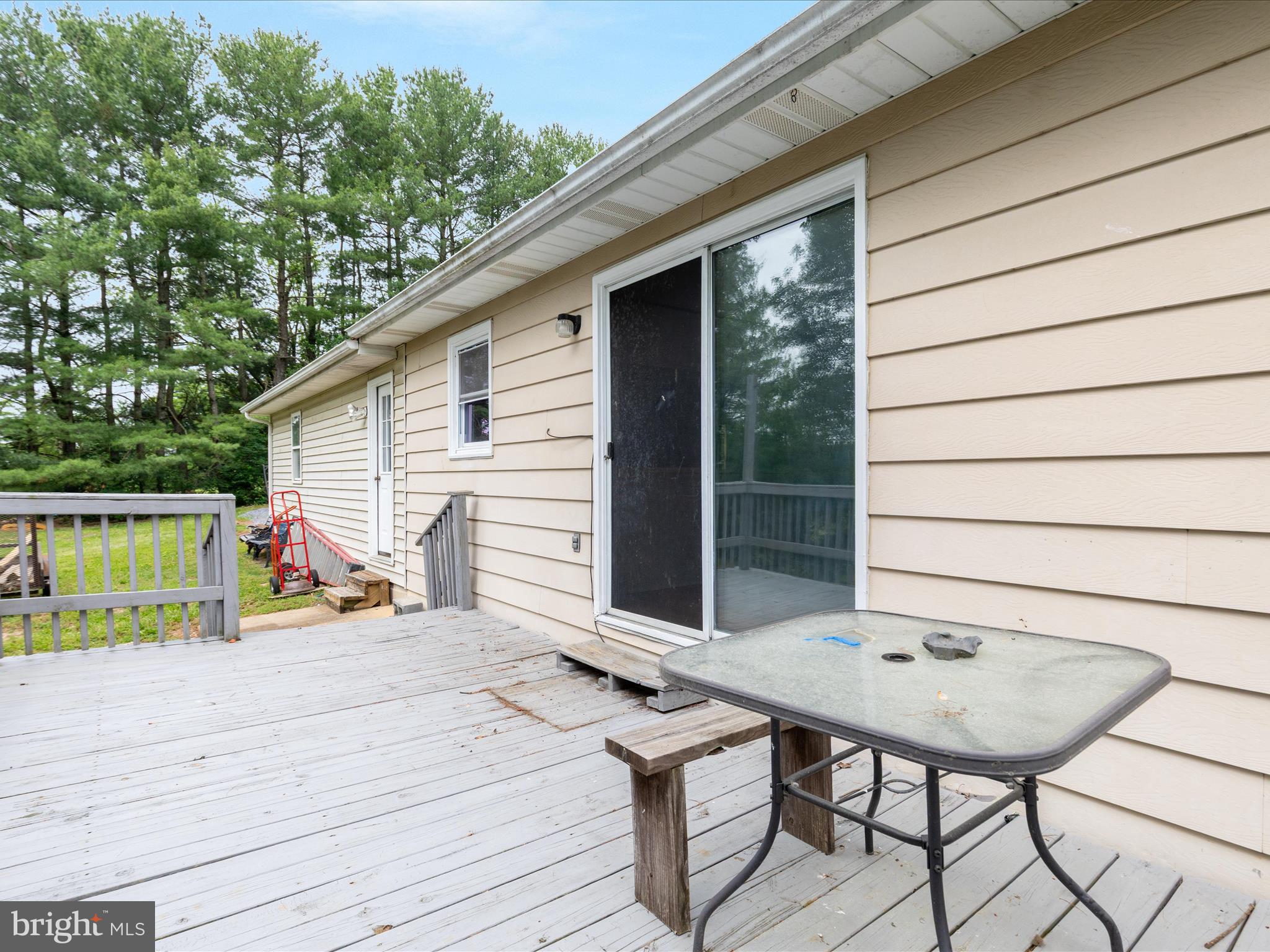 13970 Back Road Strasburg, VA 22657 - Photo 28 of 68 a backyard of a house with seating space and wooden deck