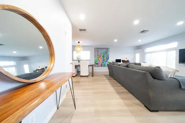 a living room with furniture and a mirror