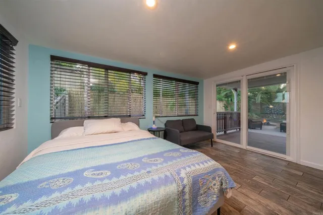 a bedroom with a large bed and a large window