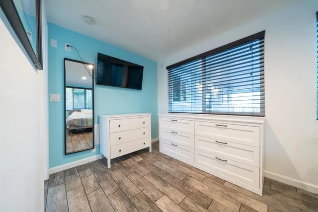 a room with a dresser and a window