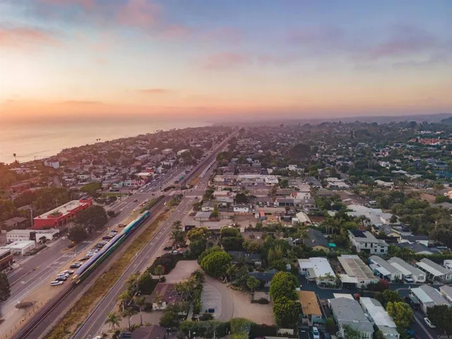 an aerial view of residential houses with city view