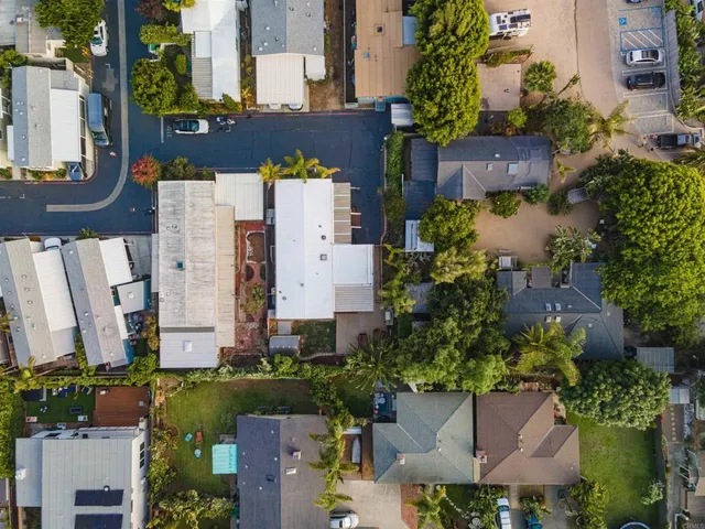 an aerial view of residential houses with outdoor space