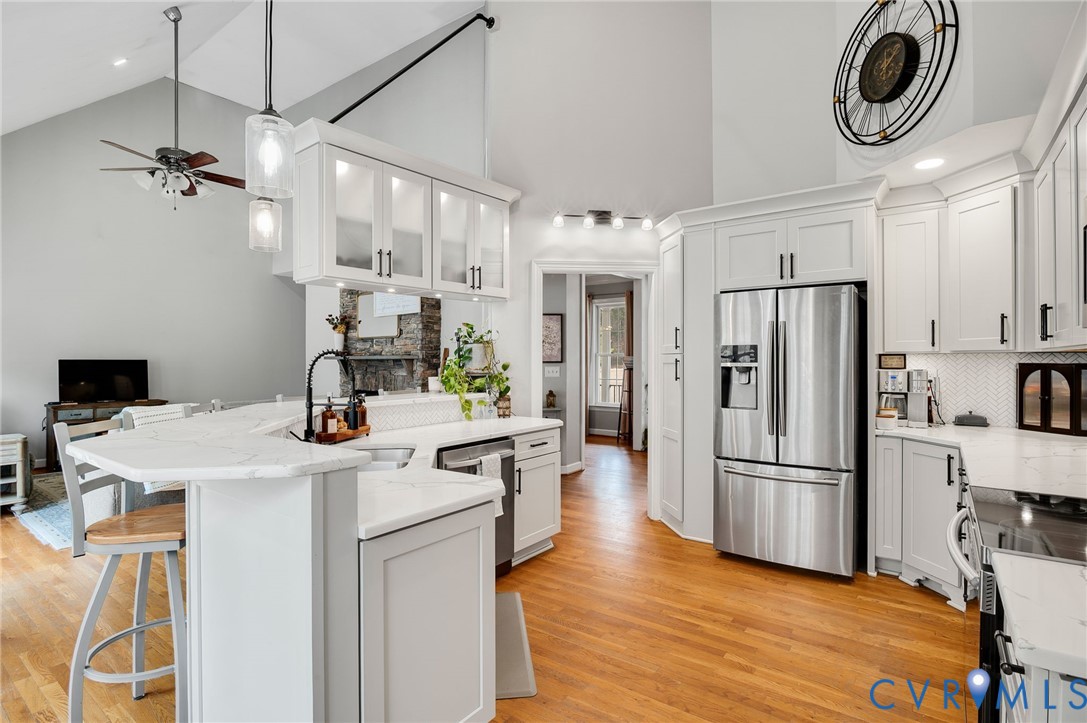 6109 Autumn Bluff Road Powhatan, VA 23139 - Photo 12 of 28 a kitchen with a refrigerator a stove top oven a sink and cabinets