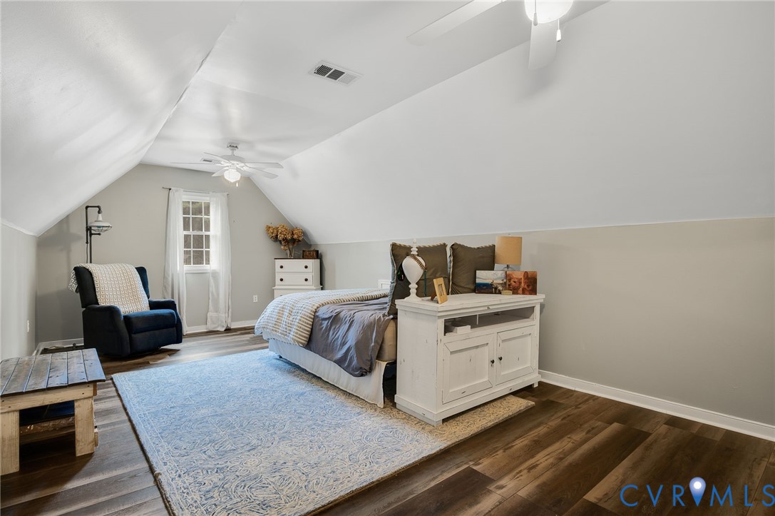 6109 Autumn Bluff Road Powhatan, VA 23139 - Photo 20 of 28 a spacious bedroom with a bed and wooden floor