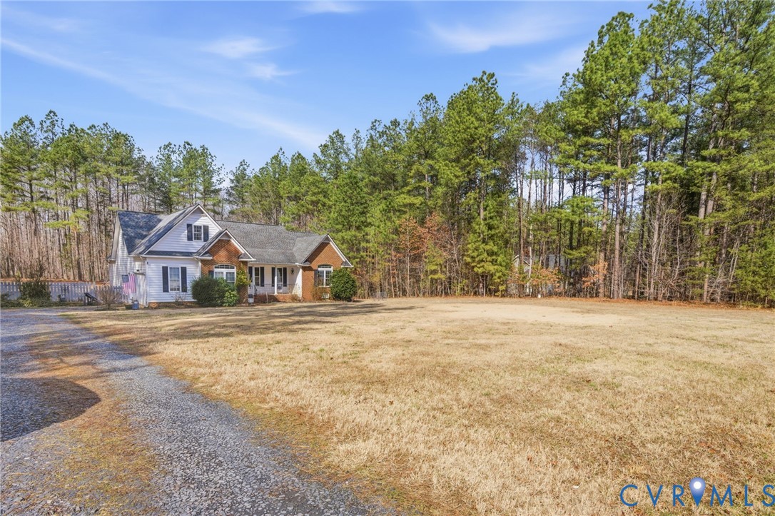 6109 Autumn Bluff Road Powhatan, VA 23139 - Photo 22 of 28 a front view of a house with a yard and trees
