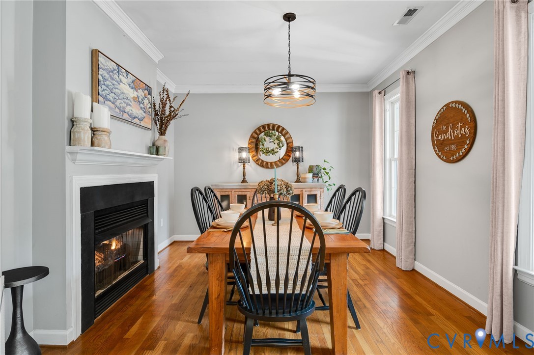 6109 Autumn Bluff Road Powhatan, VA 23139 - Photo 7 of 28 a view of a dining room with furniture wooden floor and a chandelier