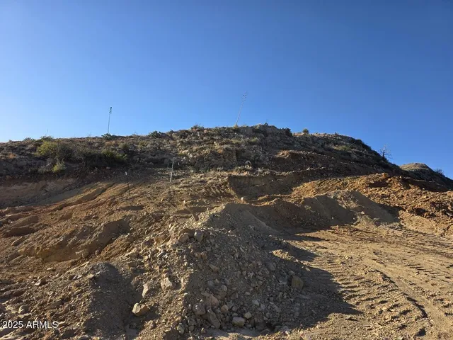 a view of a large building with mountains in the background