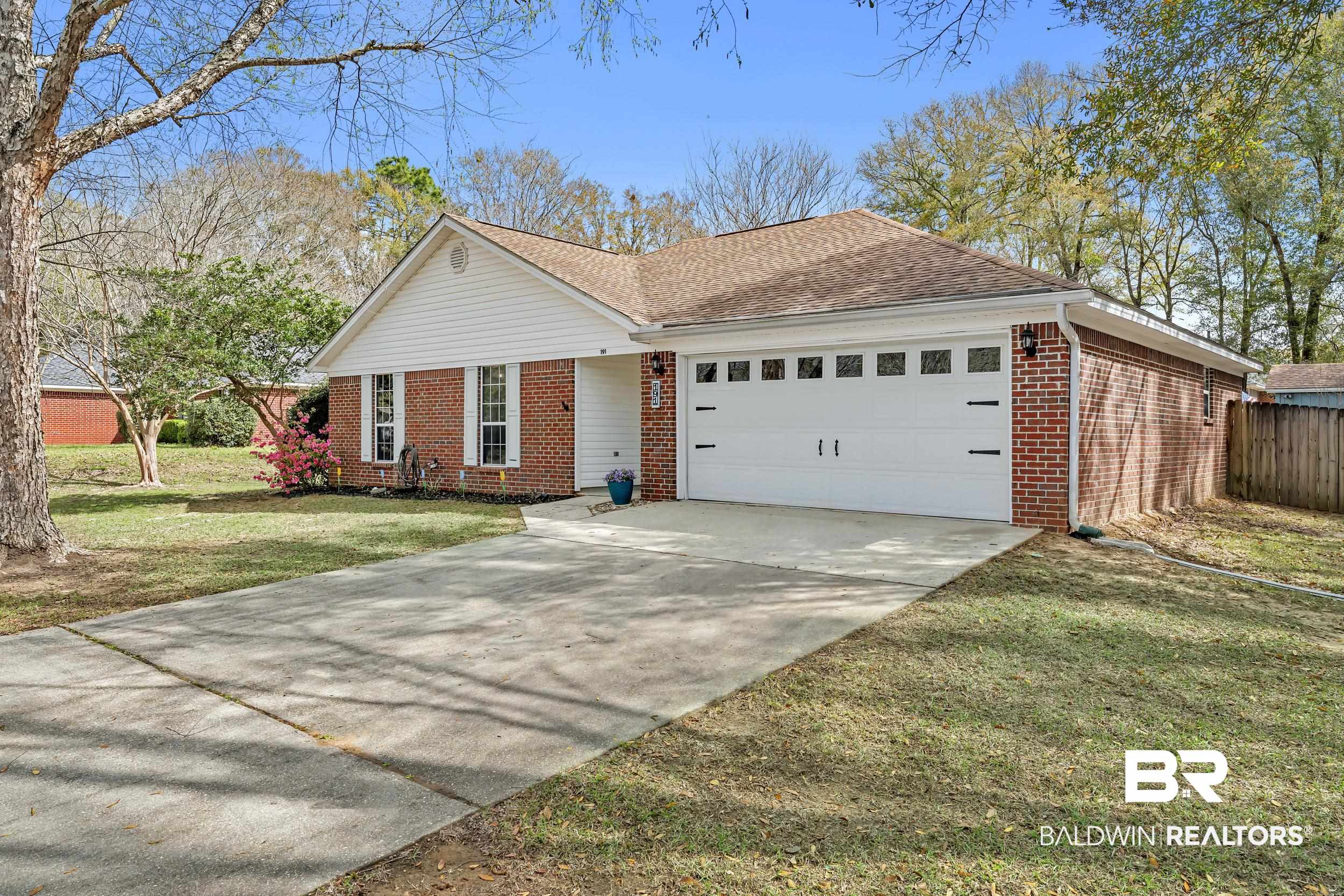 191 Robbins Boulevard Daphne, AL 36526 - Photo 3 of 24 Ranch-style house featuring brick siding, driveway, an attached garage, and a shingled roof