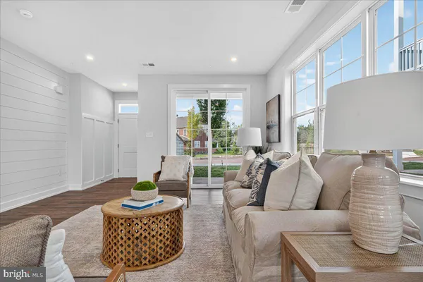 a living room with furniture a rug and a window