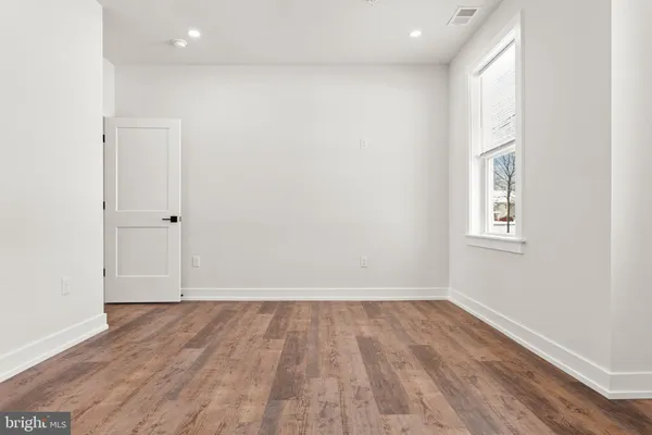 a view of room with hardwood floor and window