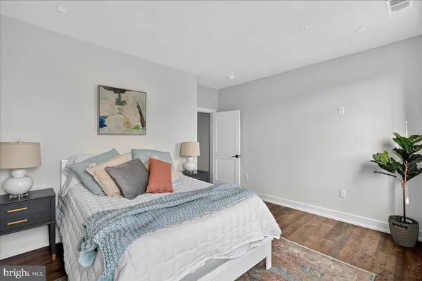 a bedroom with a bed and a potted plant