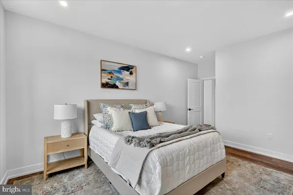 a bedroom with a bed and a painting on the wall