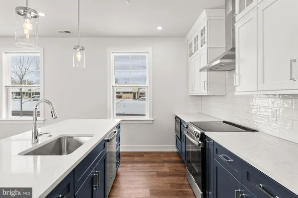 a kitchen with a sink stove and cabinets