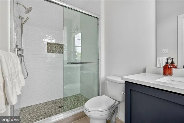 a bathroom with a sink toilet and shower