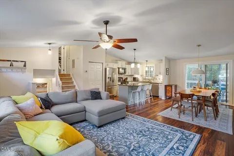 a living room with furniture wooden floor and a table