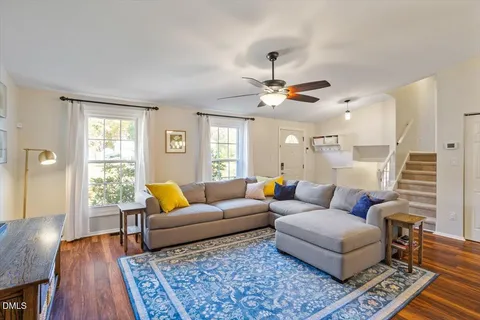 a living room with furniture and wooden floor