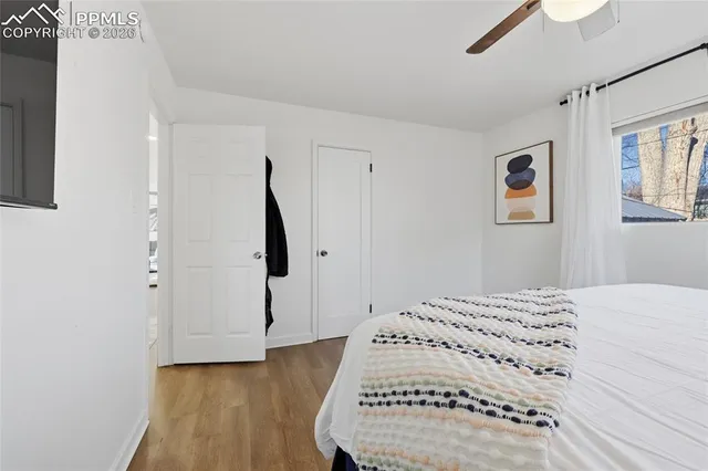 a view of a bedroom with wooden floor and hallway