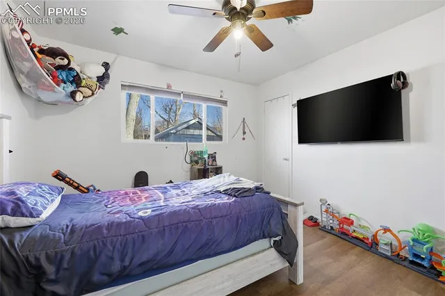 a bedroom with a bed and a flat screen tv