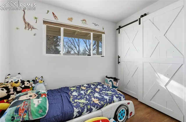 a bed room with a bed and a window