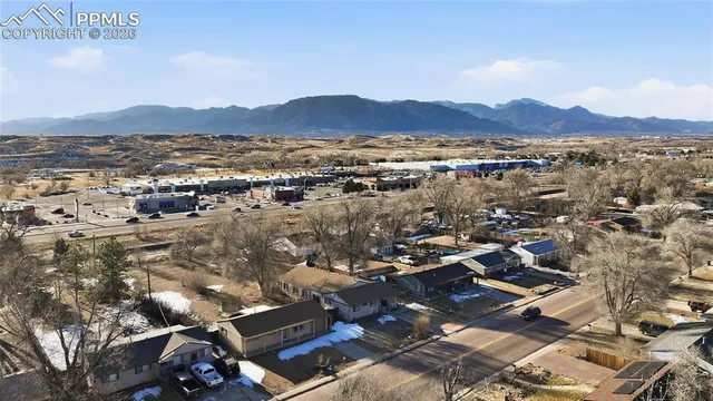 an aerial view of residential house with outdoor space and mountain view