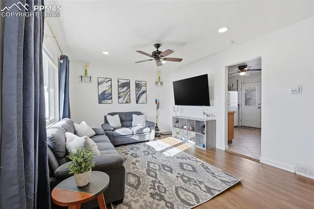 a living room with furniture and a flat screen tv