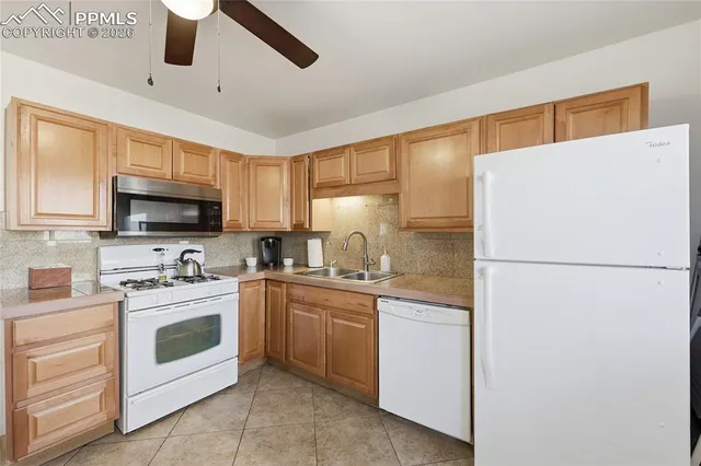 a kitchen with a sink a stove and refrigerator