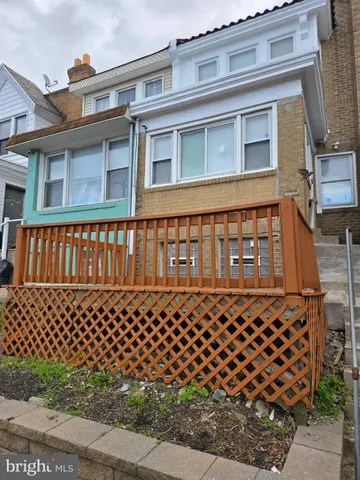 front view of a brick house with large windows