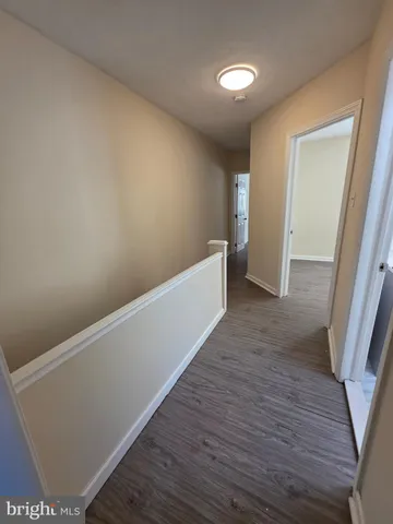 a view of hallway with wooden floor