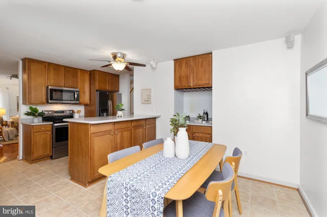 a kitchen with a table chairs microwave and cabinets