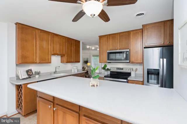a kitchen with stainless steel appliances a sink cabinets and microwave