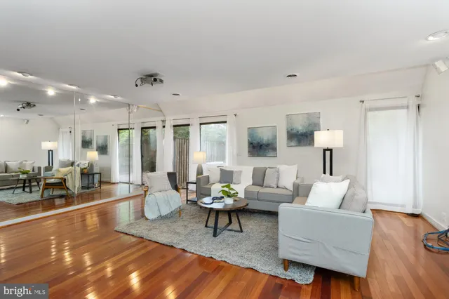 a living room with furniture and wooden floor