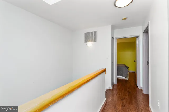 a view of a room with wooden floor