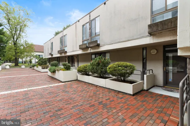 a view of a street with potted plants